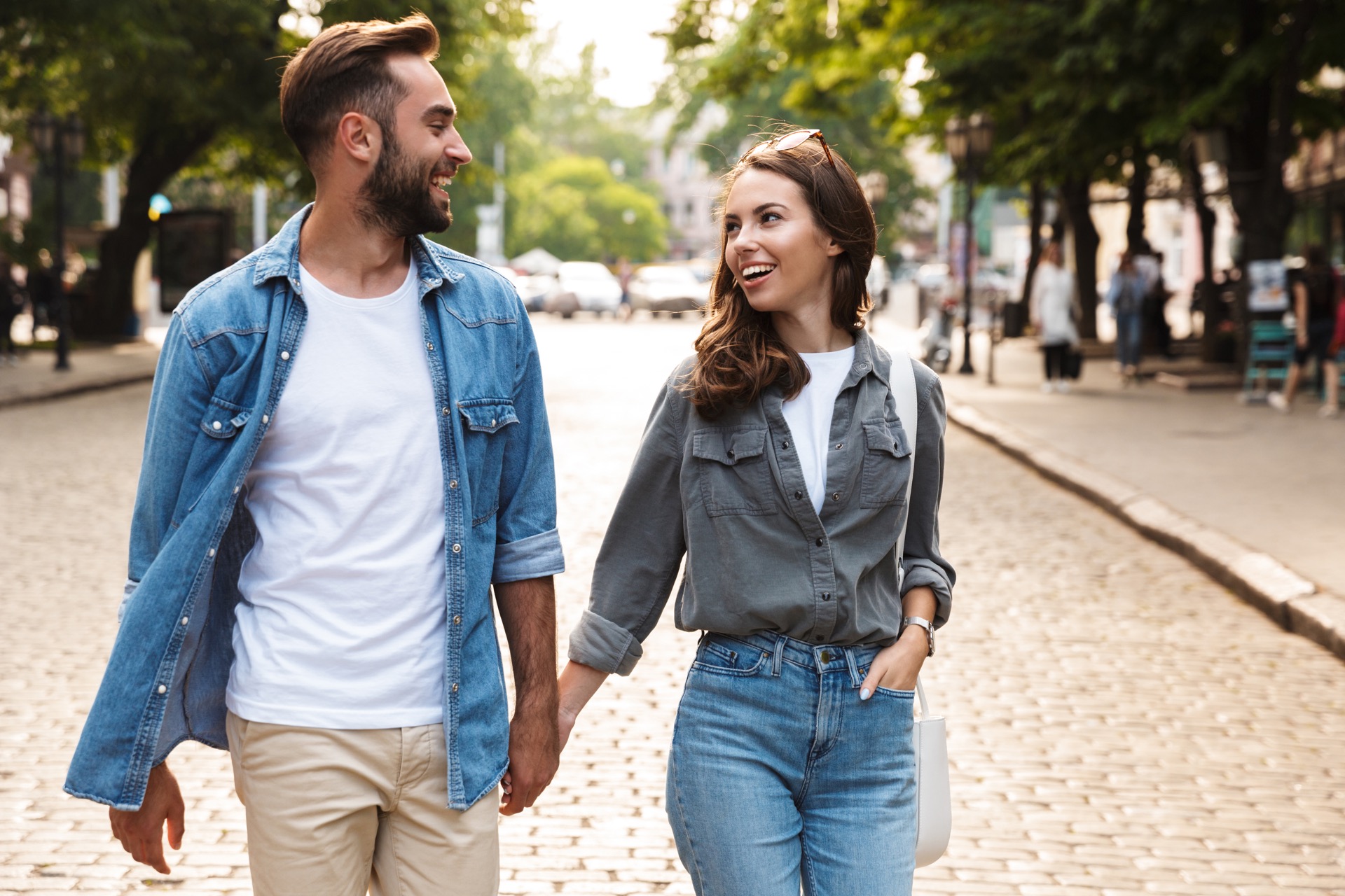 Young couple smiling and discussing life insurance plans