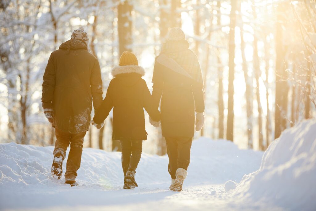 Happy family outdoors in winter after setting up life insurance