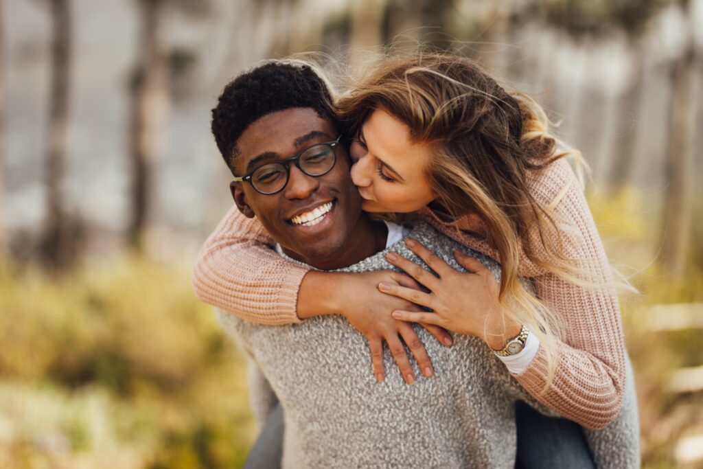 Happy interracial couple after getting term life insurance